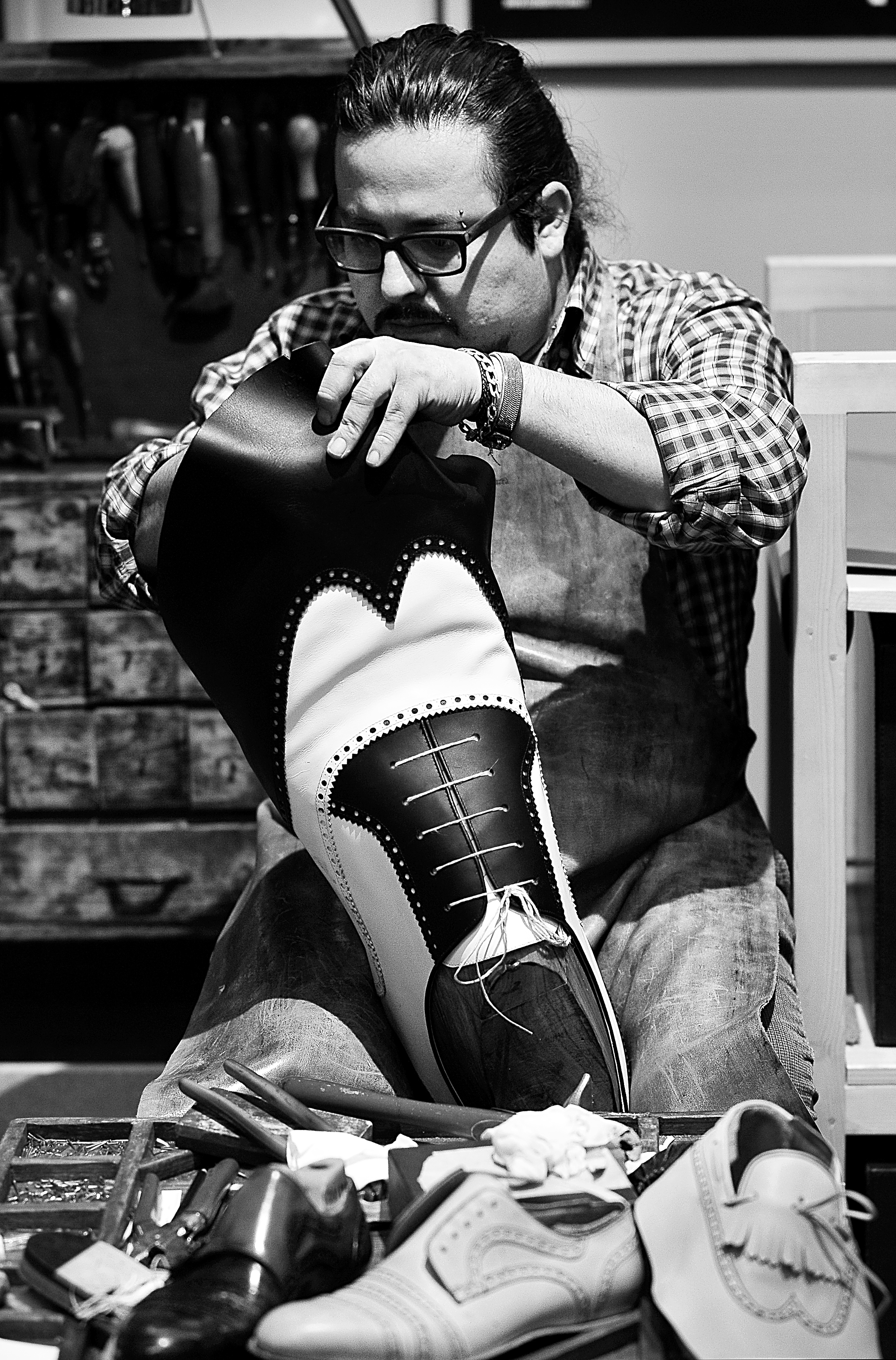 Peruvian-born, Italian educated artisan Giancarlo Zeggara, 39, crafts bespoke shoes for consortium Cuoio di Toscana at Pitti Uomo<br />
Photo by Silio Danti 