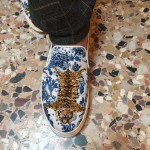 Stella Jean wears Stella Jean original loafers with a floral/tiger print