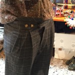 Stella Jean wears wool, plaid, pleated pants from her own collection