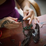 Maha Taitano links beads together by hand in her Santa Cruz studio. Photo by Devi Pride Photography